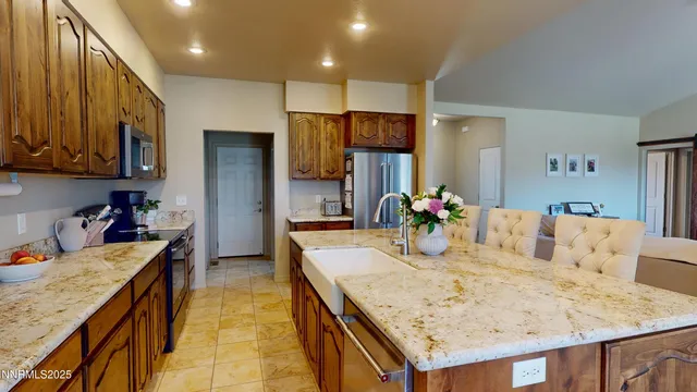 a dining room with kitchen island furniture and a chandelier