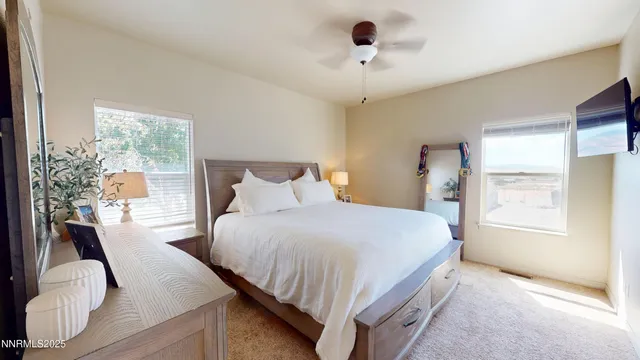 a bedroom with a large bed and a window