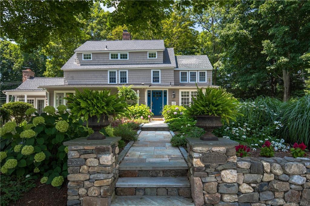 a front view of a house with a garden