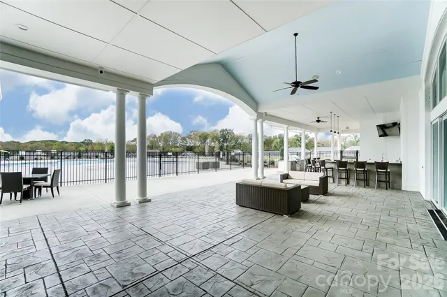 a view of a patio with a dining table chairs and garden view