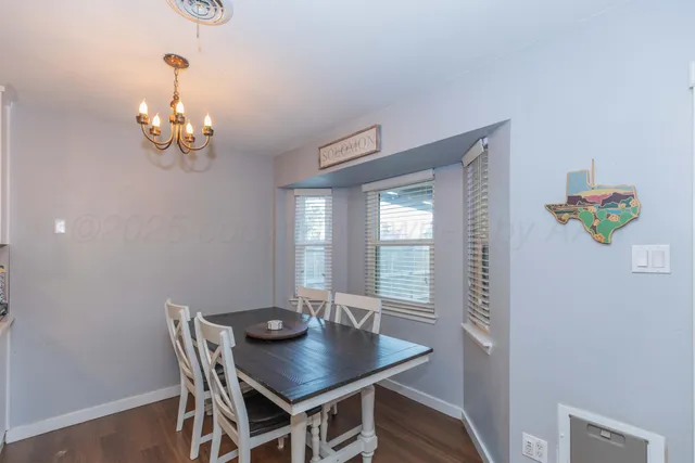 a view of a dining room with a table and chairs