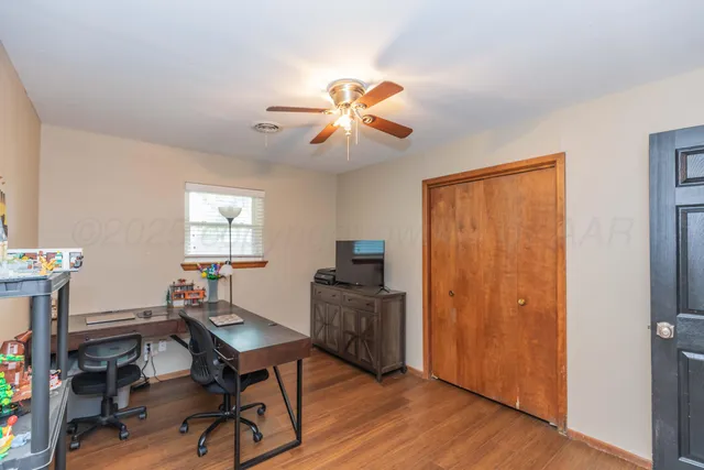 a workspace with furniture window and wooden floor