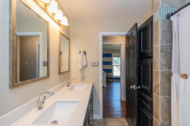 a bathroom with a tub sink and a mirror