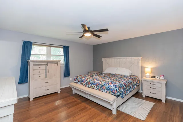 a bedroom with a bed and a dresser