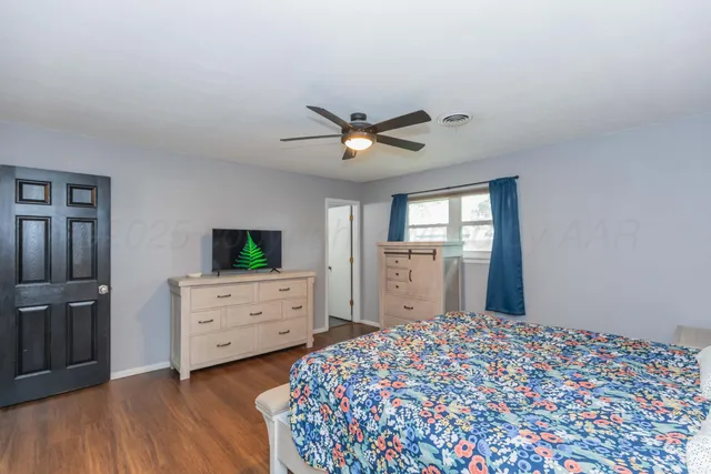 a bedroom with a bed and a dresser