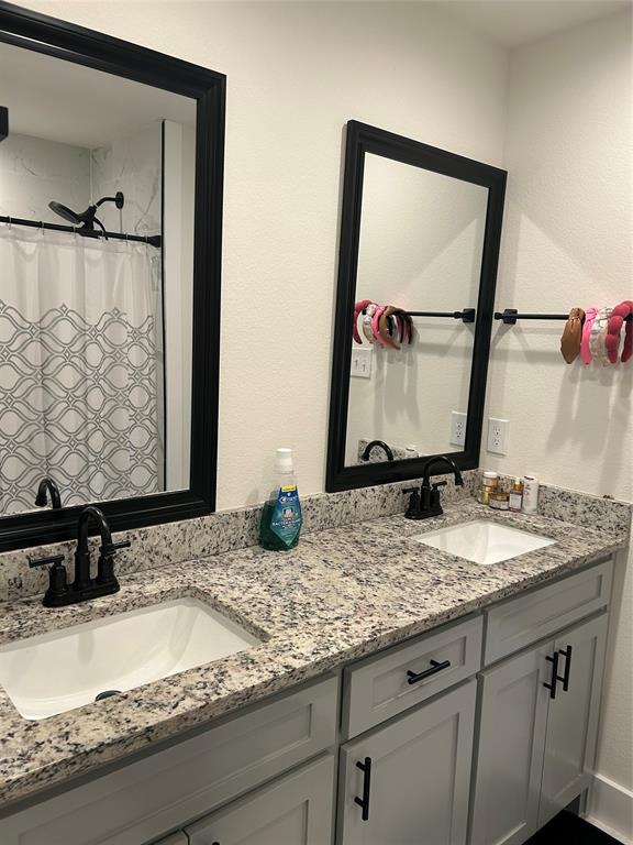 2631 Fish Tank Road Corsicana, TX 75110 - Photo 18 of 31 a bathroom with a granite countertop sink and a mirror