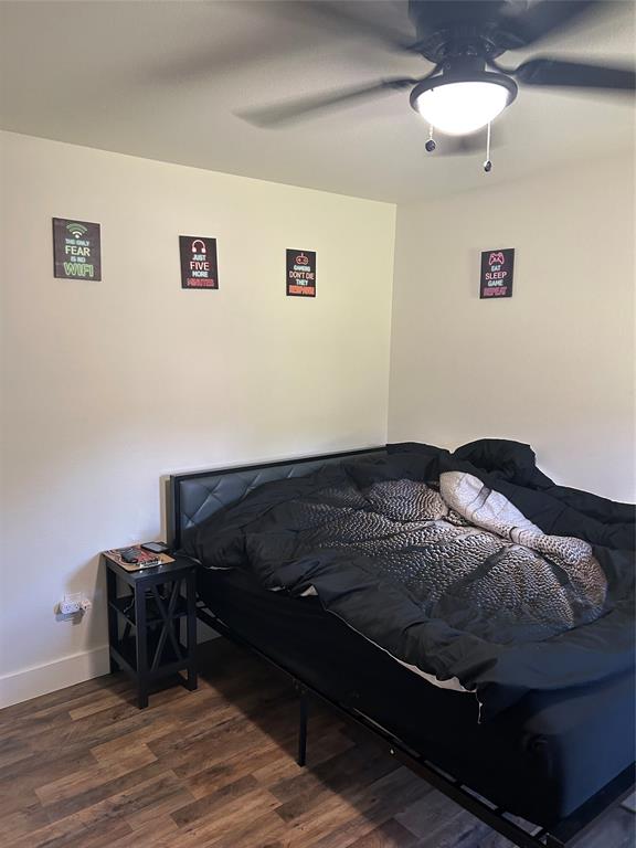 2631 Fish Tank Road Corsicana, TX 75110 - Photo 21 of 31 a bedroom with a bed and wooden floor