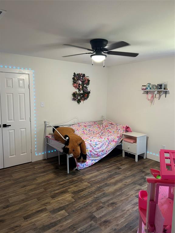 2631 Fish Tank Road Corsicana, TX 75110 - Photo 23 of 31 a bedroom with a bed and a wooden floor