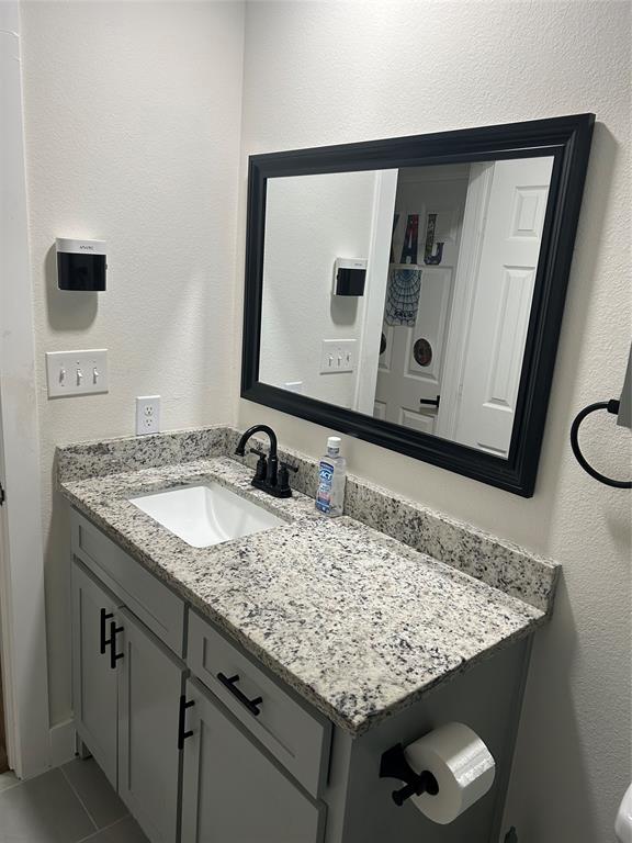2631 Fish Tank Road Corsicana, TX 75110 - Photo 29 of 31 a bathroom with a granite countertop sink and a mirror