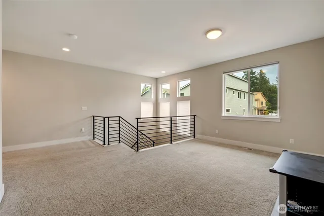a living room with a bed furniture and a large window