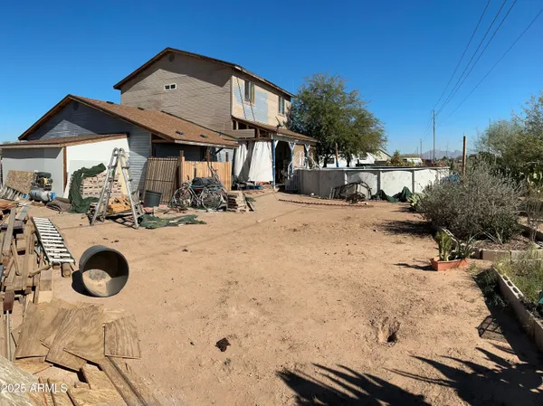 a backyard of a house with outdoor seating