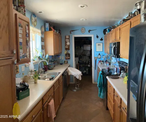 a kitchen with a sink stove and cabinets
