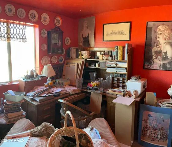 a bedroom with a bed and a computer on the desk