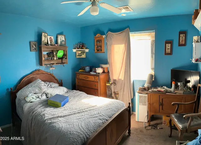 a large bed in a bedroom next to a window