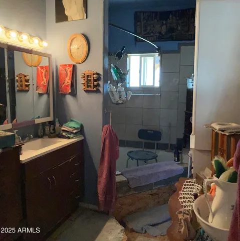 a bathroom with a sink and mirror with toilet