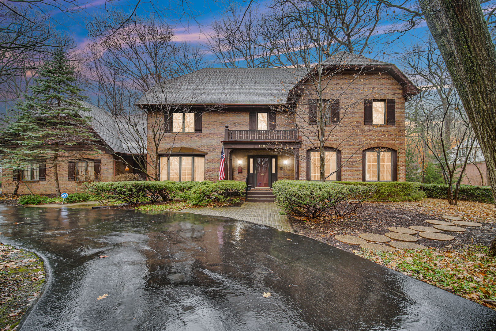 a front view of a house with yard and green space
