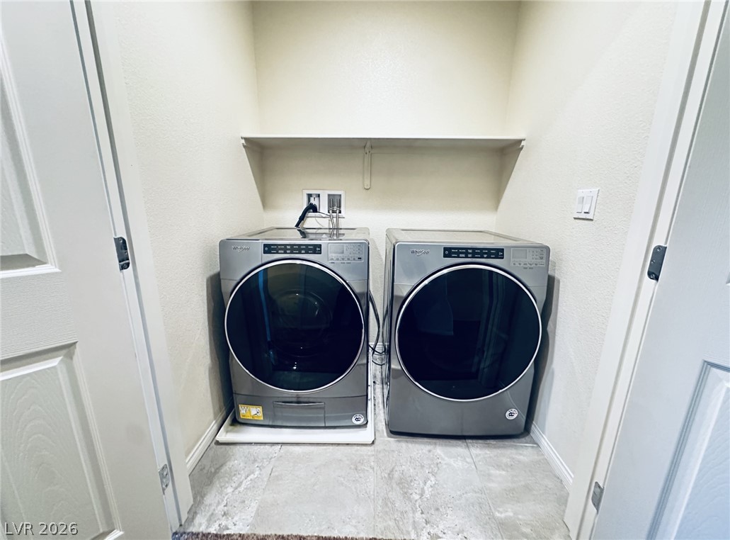 7331 Sunray Point Street North Las Vegas, NV 89084 - Photo 7 of 20 A well-appointed laundry area with modern appliances offers convenience and efficiency.