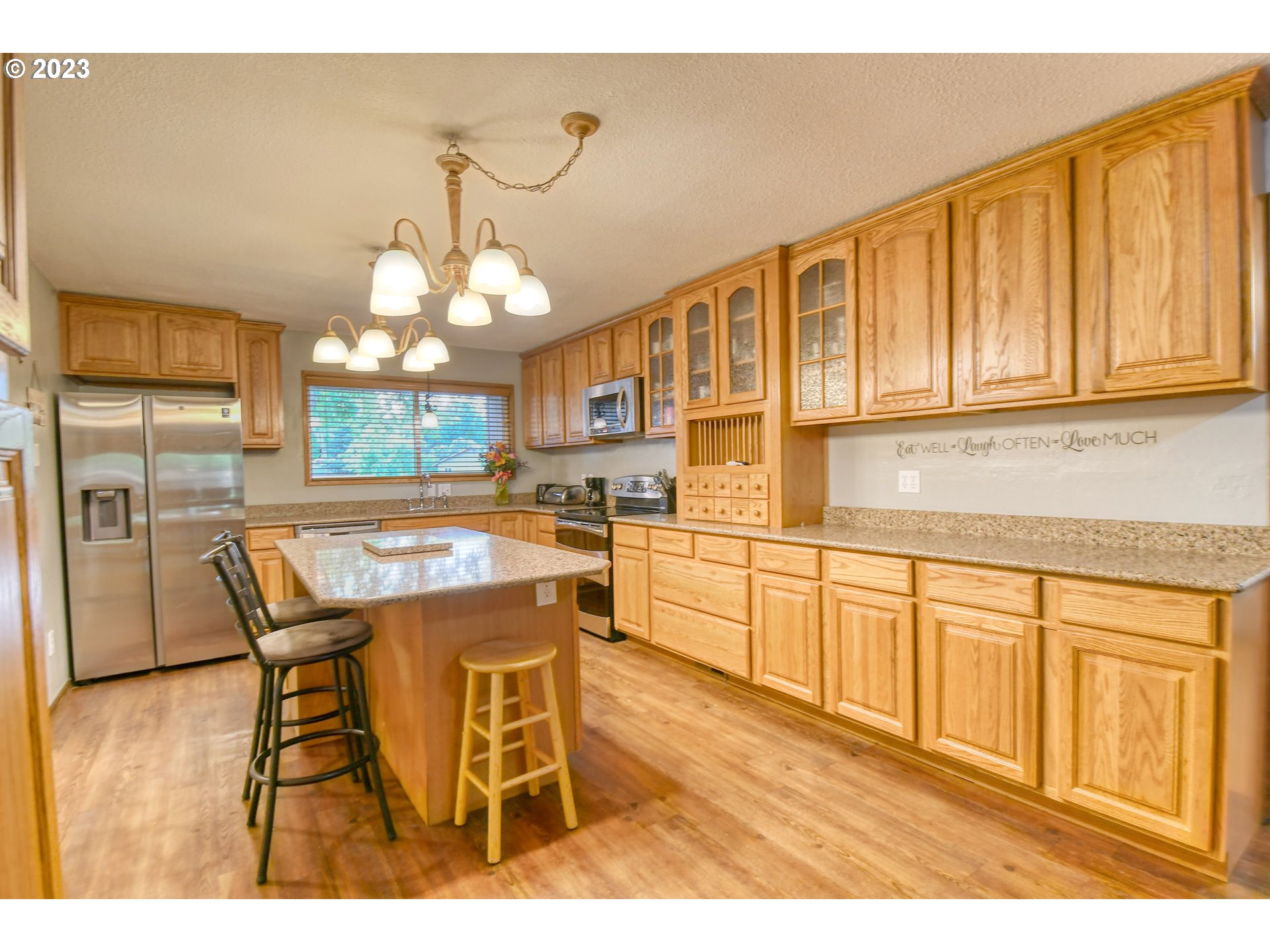 1382 Southwest 39th Street Pendleton, OR 97801 - Photo 11 of 40 a kitchen with stainless steel appliances granite countertop wooden cabinets a stove a sink and dishwasher