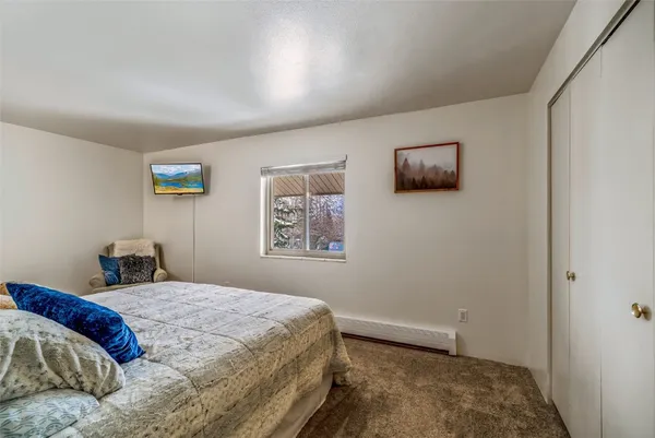 a bedroom with a bed and a wall painting