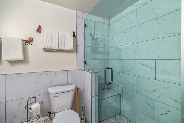 a white toilet sitting next to a bathroom sink