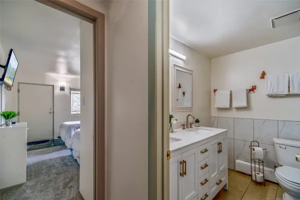 a bathroom with a sink double vanity and a toilet