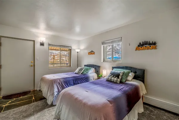 a bedroom with two beds and a window