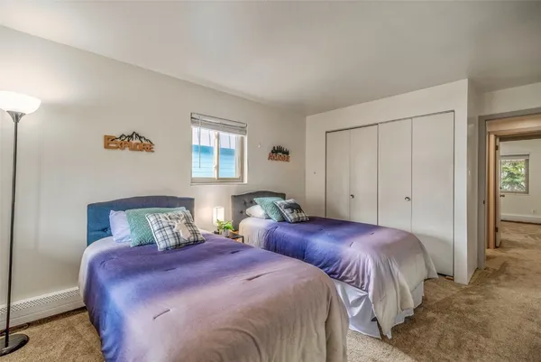 a bedroom with two beds and a window