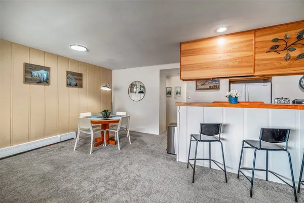 a dining room with a large window table and chairs