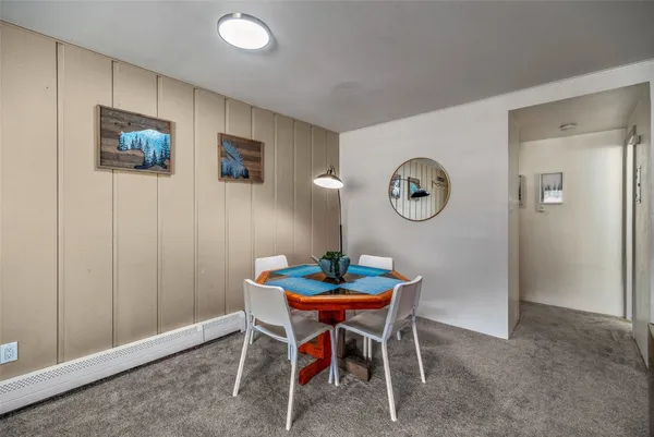 a dining room with furniture and a mirror