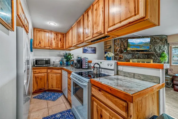 a kitchen with stainless steel appliances granite countertop a stove a sink and dishwasher