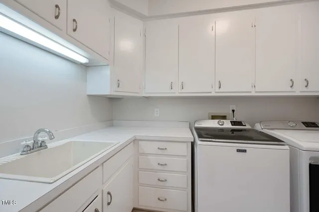 a view of cabinets a sink and dishwasher in a white cabinet