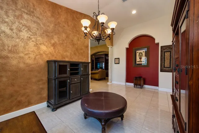 a living room with fireplace furniture and a chandelier