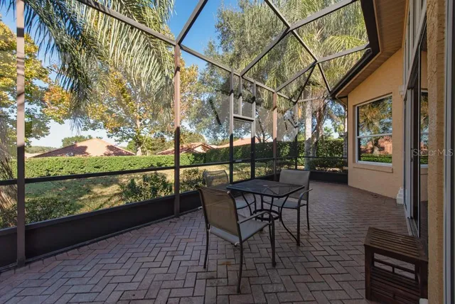 a view of a chairs and table in patio with a lake view