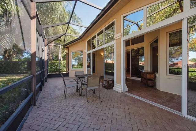 a view of a patio with table and chairs and wooden floor