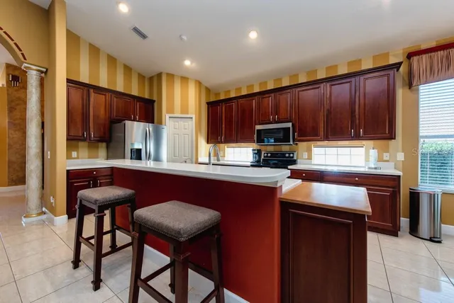 a kitchen with stainless steel appliances granite countertop wooden cabinets a stove top oven a sink and dishwasher