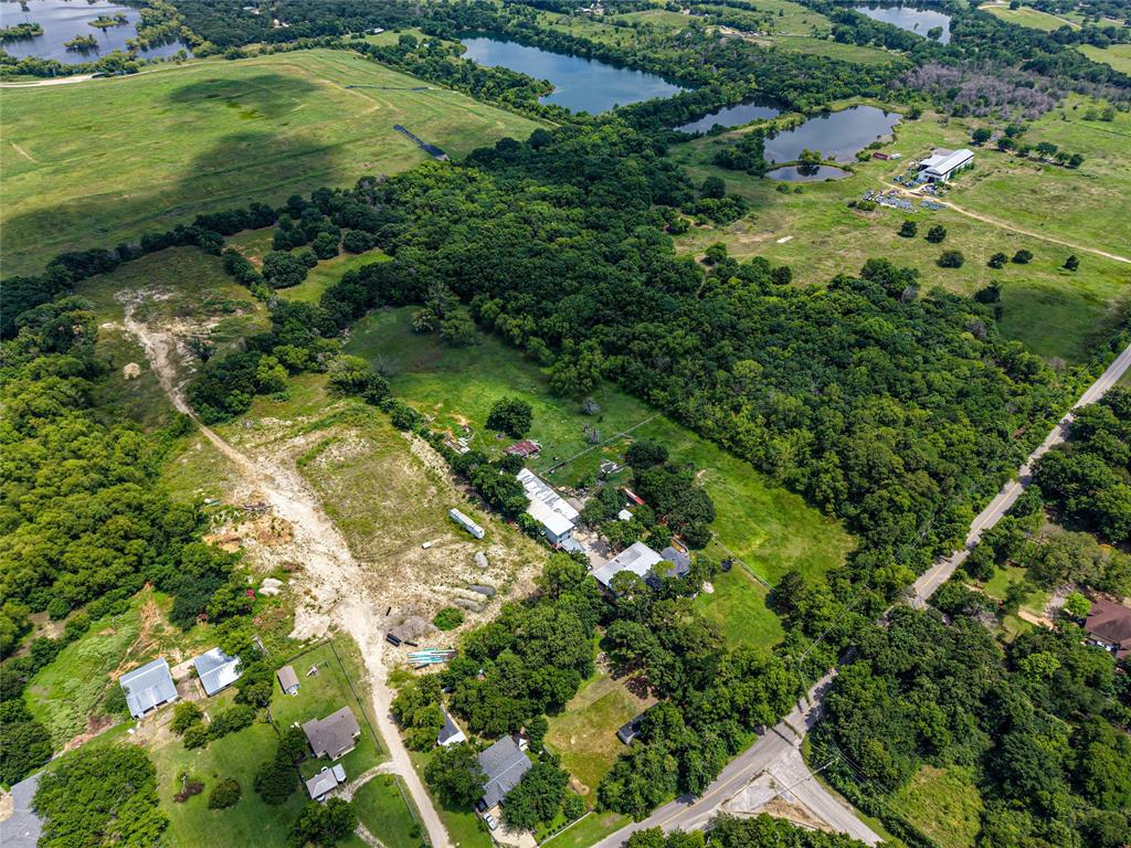 1900 Haymarket Road Dallas, TX 75253 - Photo 4 of 20 Expansive rural landscape featuring a mix of mature tree cover, open fields, and multiple bodies of water