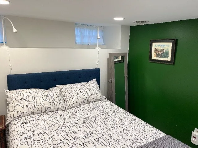 a large bed sitting in a kitchen next to a window