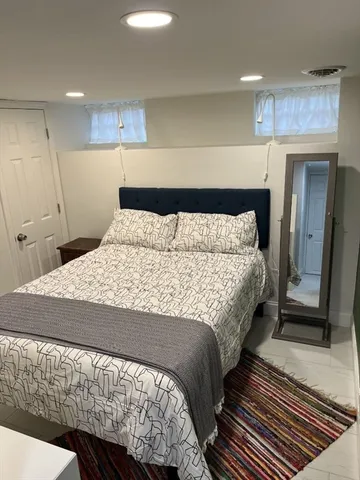 a bedroom with a bed and a mirror