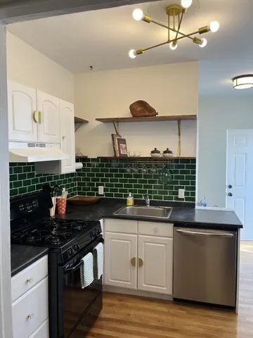 a kitchen with stainless steel appliances granite countertop a sink and cabinets