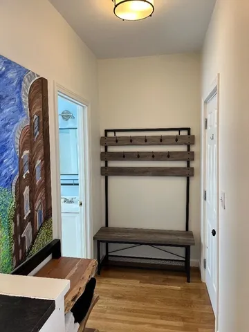 a view of room with stairs and wooden floor