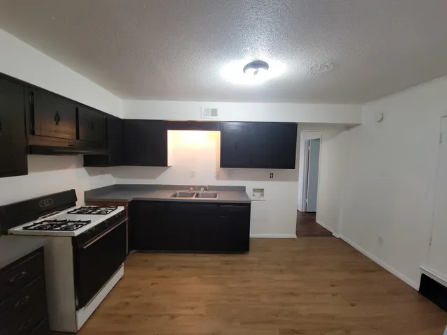 a kitchen with stainless steel appliances a stove and a refrigerator
