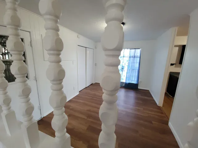 a view of entryway and hall with wooden floor