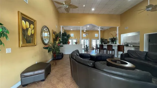 a living room with furniture and a chandelier