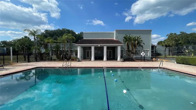 a view of swimming pool with outdoor seating