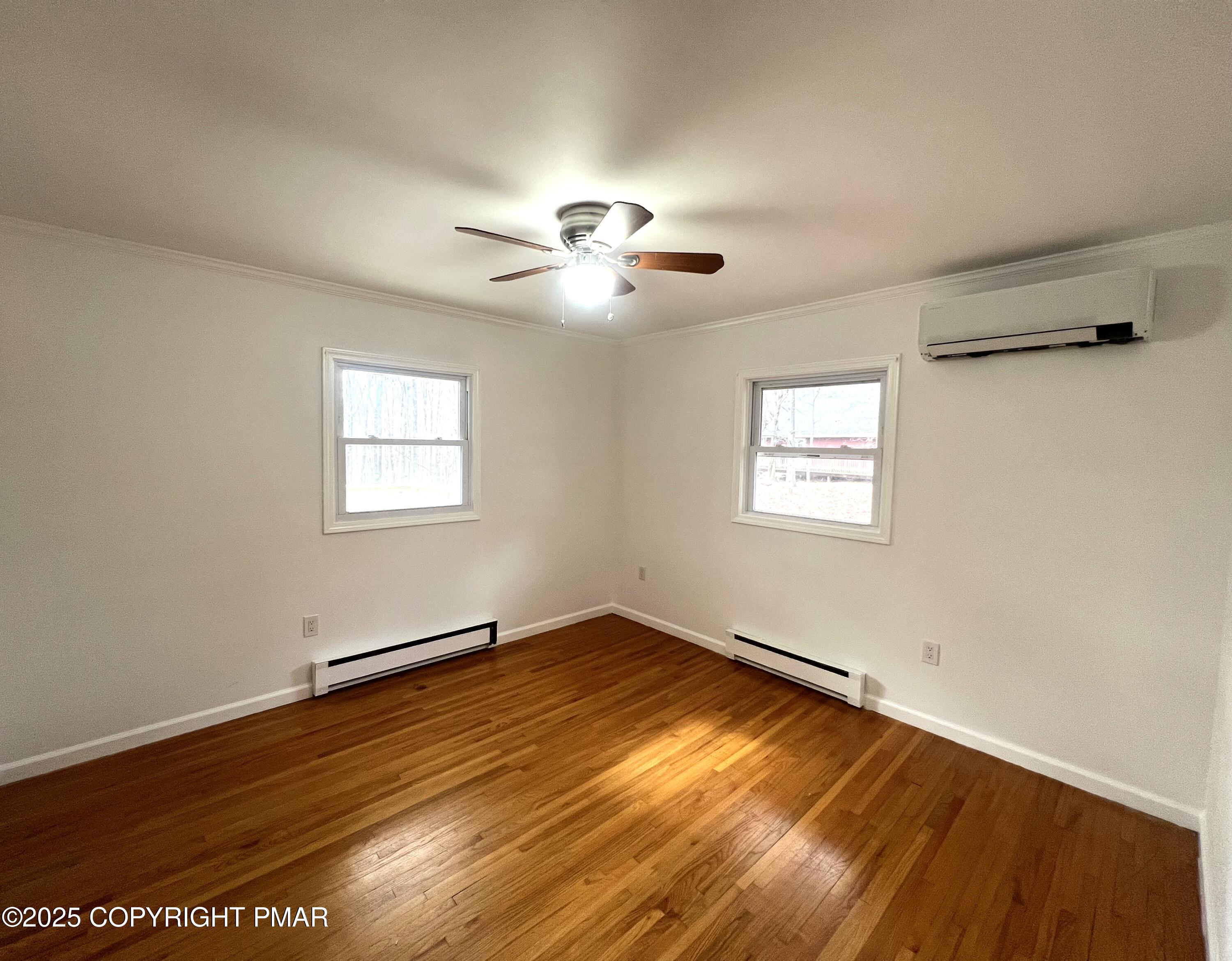 140 Davis Circle Bushkill, PA 18324 - Photo 13 of 31 a view of empty room with wooden floor and fan