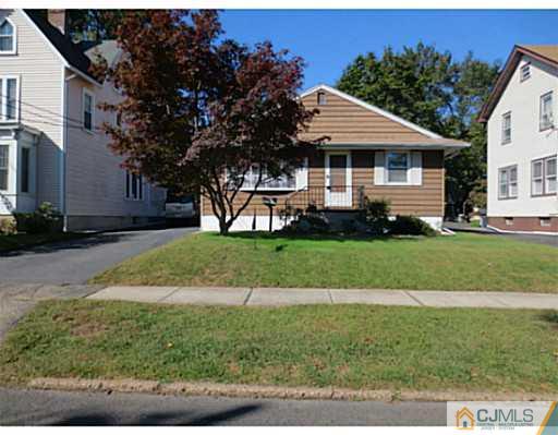 318 New Market Road Dunellen, NJ 08812 - Photo 2 of 23 a front view of a house with a yard