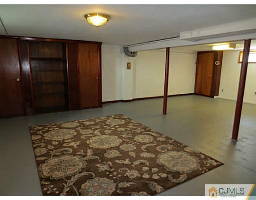 318 New Market Road Dunellen, NJ 08812 - Photo 20 of 23 a bedroom with a bed and a dresser