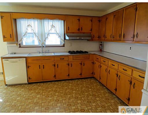 318 New Market Road Dunellen, NJ 08812 - Photo 10 of 23 a kitchen with stainless steel appliances granite countertop a sink stove and cabinets