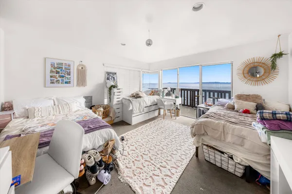 a bedroom with furniture and a wooden floor