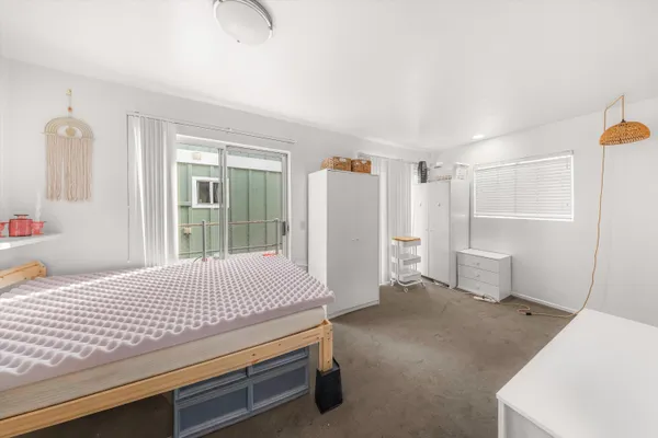 a bedroom with a bed and cabinets